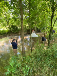 Jeff Fyke (Fyke Photography) behind the lens, knee deep in the creek to get the right angle of Blaine on her wedding day
